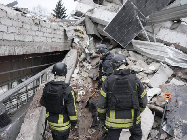 This handout photograph published on December 11, 2024, on the official Telegram channel of the head of the Zaporizhzhia Regional Military Administration Ivan Fedorov, shows rescuers searching for people under the rubble of a medical clinic destroyed by a missile in the city of Zaporizhzhia, amid the Russian invasion of Ukraine. A Russian strike on December 10, 2024, killed eight people and wounded 22 others including a five-year-old girl in the southern Ukrainian city of Zaporizhzhia. (Photo by Handout / Telegram / @ivan_fedorov_zp / AFP) / RESTRICTED TO EDITORIAL USE - MANDATORY CREDIT 