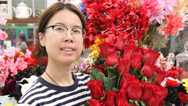 Alice Springs Phone a Flower owner Liza Jiang holds a bunch of roses. Picture: Gera Kazakov