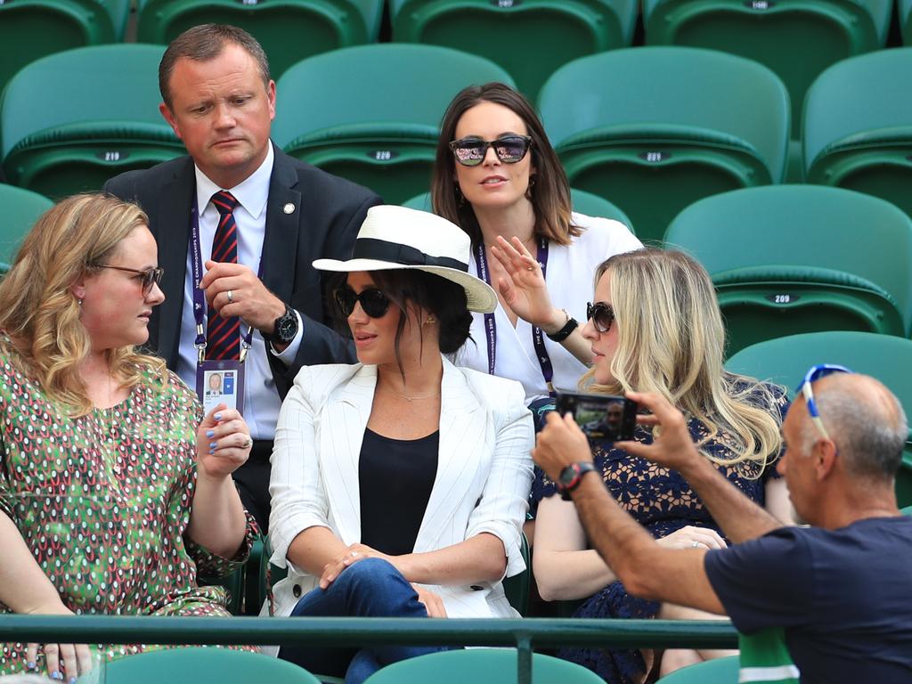 Meghan was left red-faced after her bodyguard asked this man to stop taking photos of her — when he was in fact snapping a selfie with the court in the background. Picture: Mike Egerton/PA Wire