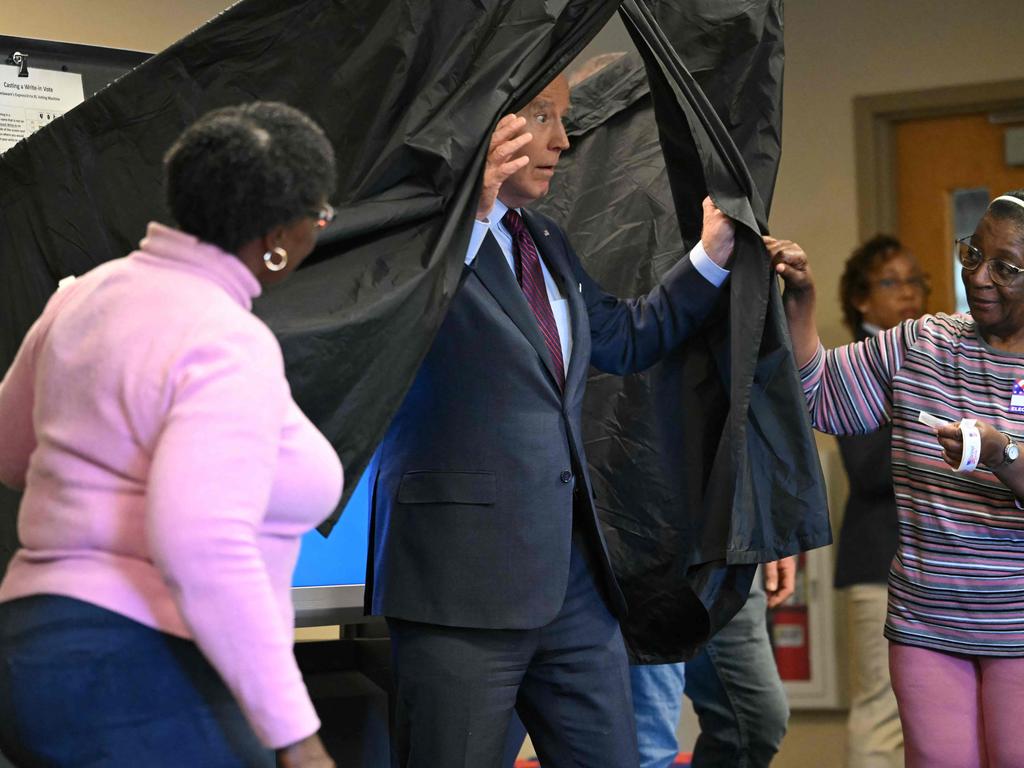 TOPSHOT - US President Joe Biden steps out of the booth after casting his early-voting ballot in the 2024 general election in New Castle, Delaware, on October 28, 2024. (Photo by ANDREW CABALLERO-REYNOLDS / AFP)