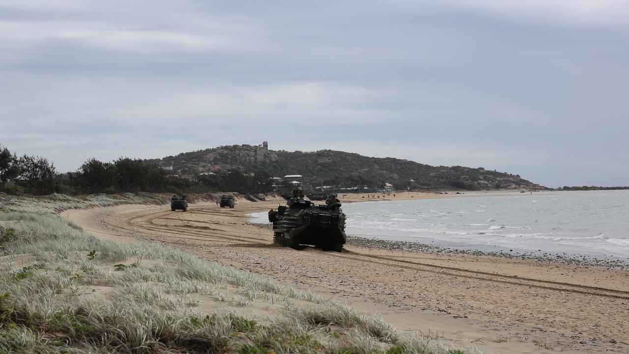 A series of Japanese and United States AAVP-7A1 amphibious vehicles track their way up Kings Beach in Bowen.