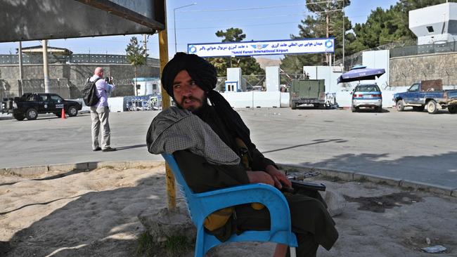 A Taliban fighter stands guard outside of Kabul airport. Picture: AFP