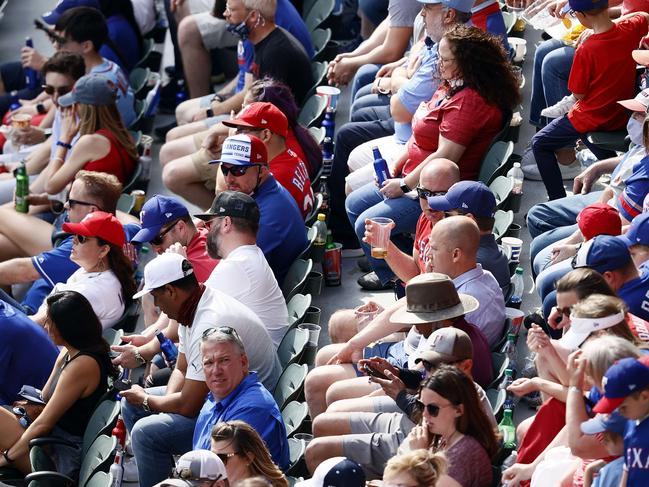 ARLINGTON, TEXAS - APRIL 05: Fans look on as the Texas Rangers take on the Toronto Blue Jays in the fourth inning on Opening Day at Globe Life Field on April 05, 2021 in Arlington, Texas.   Tom Pennington/Getty Images/AFP == FOR NEWSPAPERS, INTERNET, TELCOS & TELEVISION USE ONLY ==