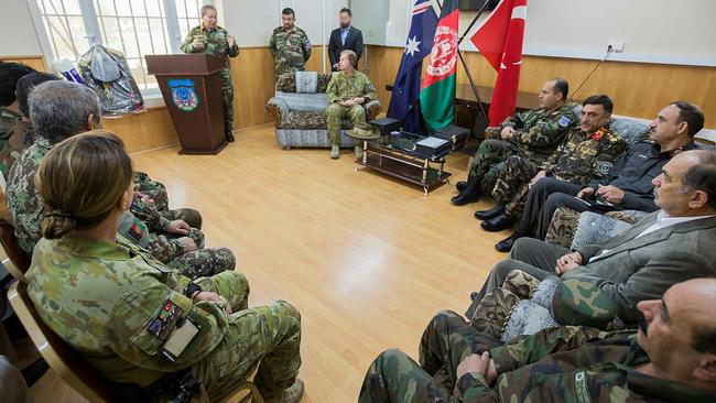 FAR CRY FROM NOW: Afghan and Australian staff from Kabul Garrison Command enjoy a joke during the Advisory Team transfer of authority ceremony in Kabul, Afghanistan in 2018. Picture: Department of Defence