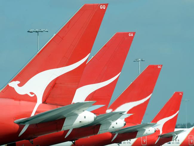 **FILE** A Dec. 3, 2008 file photo of the tails of Qantas jets at Sydney International Airport. Qantas Airways Ltd's first-half profit slumped 66 per cent, Wednesday, Feb. 4, 2009, as fuel and labour costs buffeted Australia's biggest airline. (AAP Image/Dean Lewins,File) NO ARCHIVING