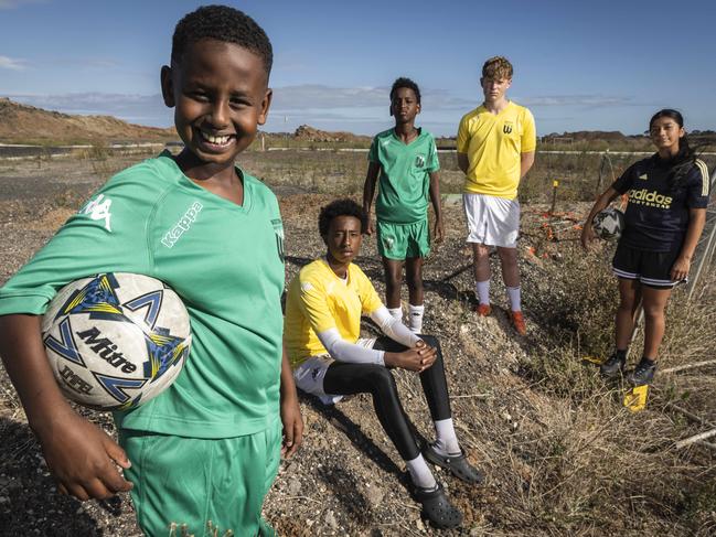 Zak Yusuf (9), Abdulamilk Yusuf (14), Yussuf Hussein (11), Flynn Slater (15) and Madison Pavez (13) in the spot where a new soccer facilities will be built in Tarneit. Picture: Jake Nowakowski