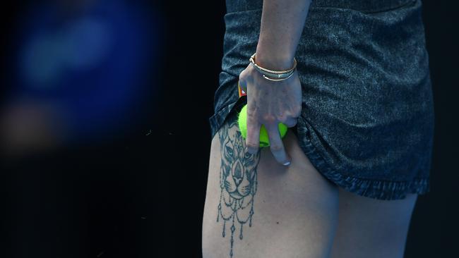 Elina Svitolina shows off a tattoo during her match against Viktoria Kuzmova.