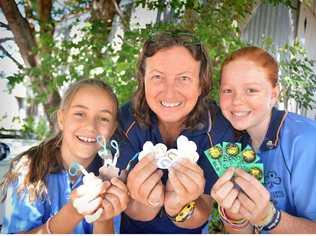 Rhiannon and Leonora Cox and Savanna Stey have their Gympie tokens ready to trade at the Australian International Guide Jamboree in Tasmania. Picture: Renee Pilcher