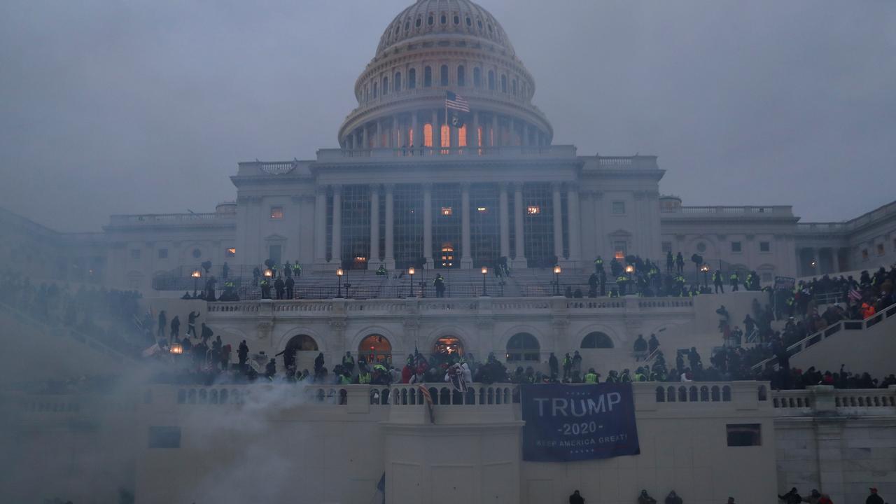 Police officers stand guard as supporters of President Donald Trump gather in front of the Capitol Building in Washington DC. Picture: REUTERS/Leah Millis.