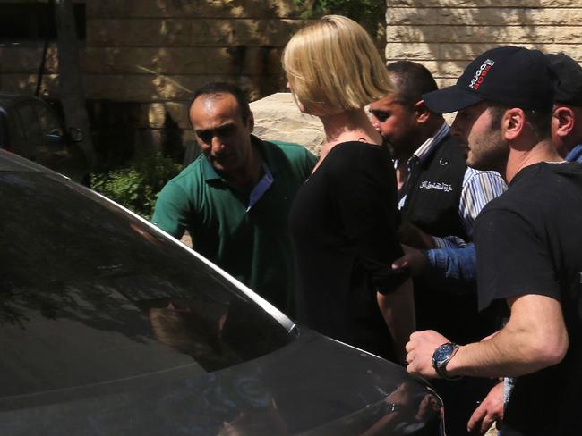 Lebanese policemen surround TV presenter Tara Brown. Picture: AFP