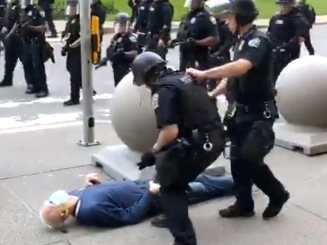 Martin Gugino on the ground as police stand near him. Picture: AFP