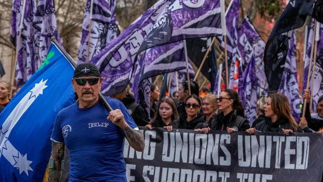 MELBOURNE, AUSTRALIA - AUGUST 27: CFMEU members march shouting slogans on August 27, 2024 in Melbourne, Australia. Thousands of union members across Victoria participated in a march on Tuesday morning to show solidarity with the Construction, Forestry, Maritime, Mining and Energy Union (CFMEU). The strikes come in response to new legislation that forces the CFMEU to accept administration following allegations of criminal links and corruption. The new legislation, which passed the Senate with support from the Opposition, gives the relevant minister the power to appoint an administrator. The CFMEU has criticized the law, saying it stripped members of the right to a fair process and has flagged a legal fight. Prime Minister Anthony Albanese dismissed the union's criticism, stating that it is "business as usual from the CFMEU". (Photo by Asanka Ratnayake/Getty Images)