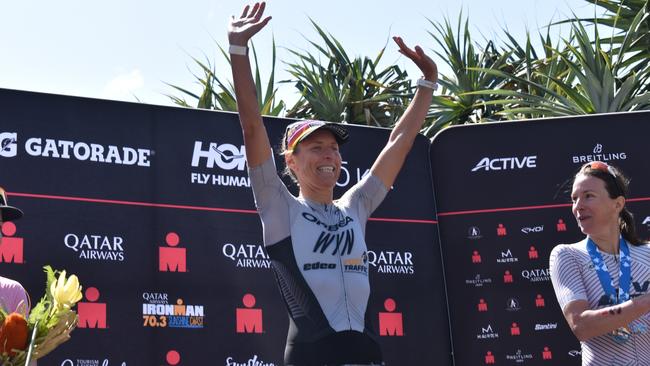 Women's first place: Rebecca Clarke on the podium at the Sunshine Coast Ironman 70.3 2023.