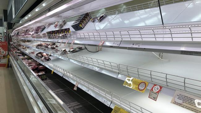 The number of workers in isolation across the supply chain has resulted in empty supermarket shelves. Picture: Glenn Hampson