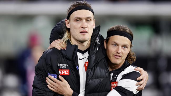 MELBOURNE, AUSTRALIA - AUGUST 11: Jack Ginnivan of the Magpies shares an embrace with Darcy Moore of the Magpies as Moore is subbed out of the game during the round 22 AFL match between Collingwood Magpies and Geelong Cats at Melbourne Cricket Ground, on August 11, 2023, in Melbourne, Australia. (Photo by Darrian Traynor/Getty Images)