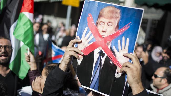 Protesters hold a portrait of Donald Trump in Jerusalem, Israel. Photo: Getty Images