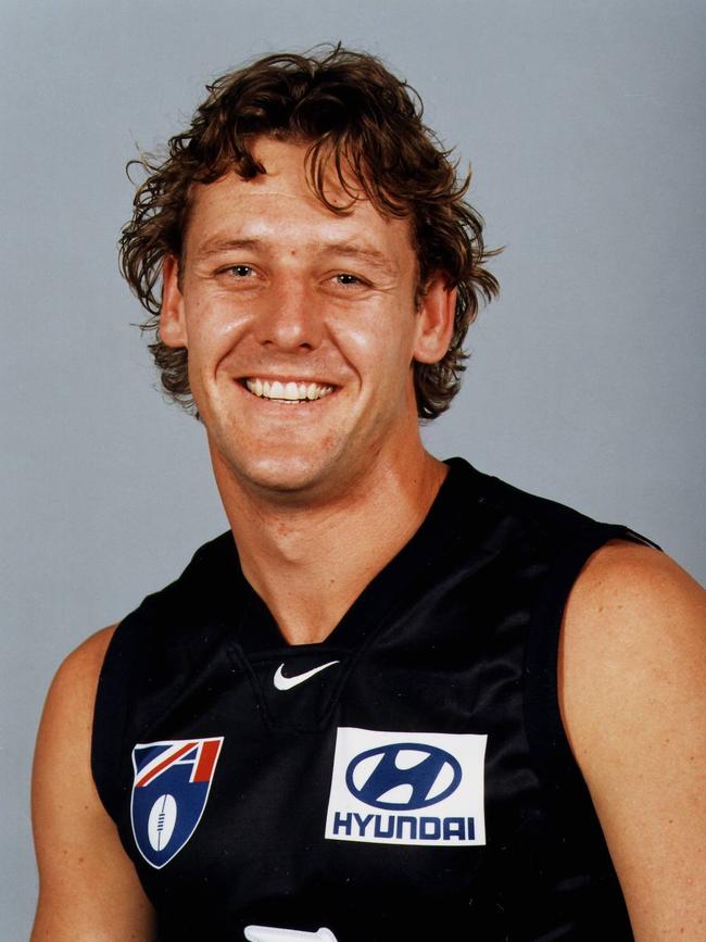 Andrew Balkwill wearing Carlton’s navy blue guernsey for a team photo.