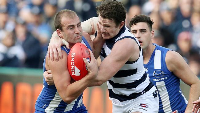 North Melbourne’s Ben Cunnington tackled by Geelong’s Patrick Dangerfield. Pic: Michael Klein