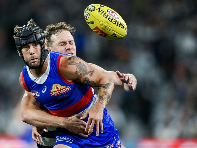 ADELAIDE, AUSTRALIA - APRIL 06:  Caleb Daniel of the Bulldogs  competes with  Mitch Duncan of the Cats during the round four AFL match between Western Bulldogs and Geelong Cats at Adelaide Oval, on April 06, 2024, in Adelaide, Australia. (Photo by Mark Brake/Getty Images)