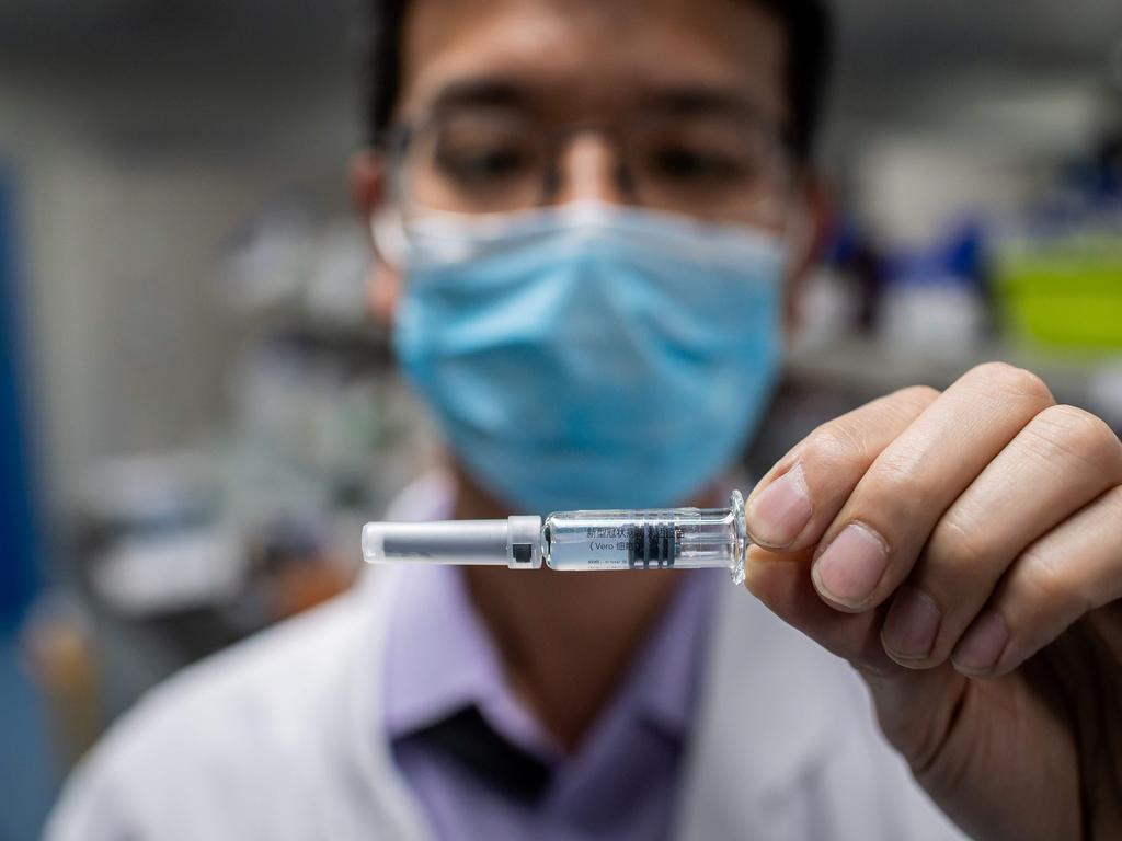 An engineer shows an experimental vaccine for the COVID-19 coronavirus that was tested at the Quality Control Laboratory at the Sinovac Biotech facilities in Beijing on April 29. Picture: Nicolas Asfouri/AFP