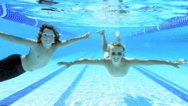 Finn Chandler (9) and Jack Dickson (9) have a swim during a break of their school's swim trials held at Pines Forest Aquatic Centre, Frankston North. Picture: Jason Sammon.