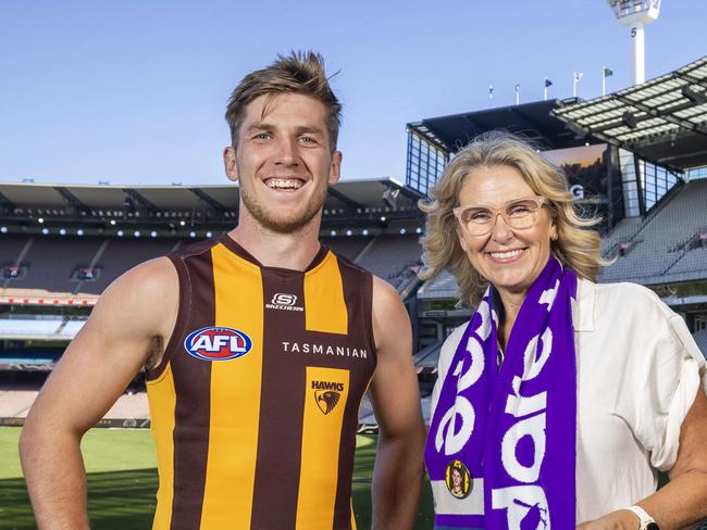 Hawthorn player Dylan Moore at the MCG who wears the number 13 which is Paul Dear's former jumper. The game will raise funds for pancreatic cancer research. Pictured with Paul Dears wife Cherie.Picture by Wayne Taylor 27th March 2024