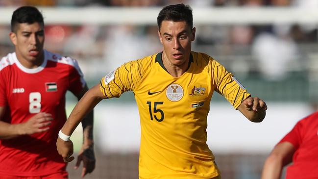 DUBAI, UNITED ARAB EMIRATES - JANUARY 11:  Chris Ikonomidis of Australia is challanged by Jonathan Zorrilla of Palestine and Alexis Norambuena of Palestine during the AFC Asian Cup Group B match between Palestine and Australia at Rashid Stadium on January 11, 2019 in Dubai, United Arab Emirates. (Photo by Francois Nel/Getty Images)