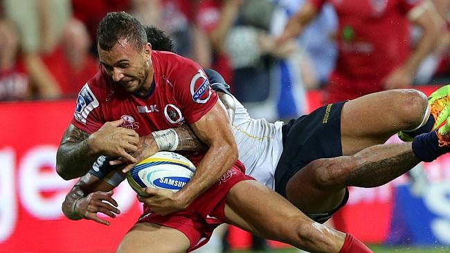 Quade Cooper of the Reds loses the ball over the try line in the tackle of Joe Tomane of the Brumbies during the Super Rugby match between the Queensland Reds and the Brumbies. Pic Darren England.