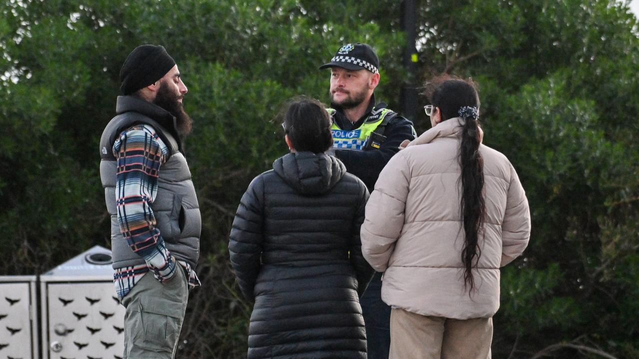 Police talk to people as emergency services search for a 17yo boy who was seen floating in seas on the southern side of Granite Island at Victor Harbor. Picture: Brenton Edwards