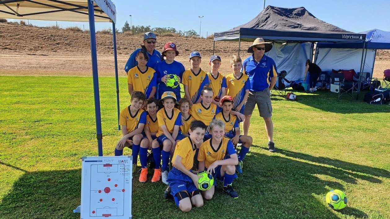HAPPY TEAM: Back Row - Mark Holmes, Leyden Sailor, Jimmy Keogh, Lincoln McErlain, Jack Lamberton, Xavier Blomfield, James Hoger (manager). Middle row -Eamon Ruhl, Daniel Gray, Kynan Holmes, Noah McClure, Tighe Butt-McGuire, Kai Codrington. Front row - Jacob Hoger, Braith Kammholz. Picture: U11 soccer - 310719