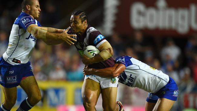 Steve Matai of the Sea Eagles is tackled by Josh Reynolds, (left), and Chase Stanley of the Bulldogs during the round 1 NRL match between the Manly-Warringah Sea Eagles and the Canterbury-Bankstown Bulldogs at Brookvale Oval in Sydney, Friday, March 4, 2016. (AAP Image/Dan Himbrechts) NO ARCHIVING, EDITORIAL USE ONLY