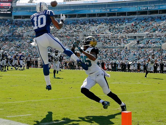 Donte Moncrief #10 of the Indianapolis Colts catches a pass inside the 10-yard line over defender Demetrius McCray #35 of the Jacksonville Jaguars.