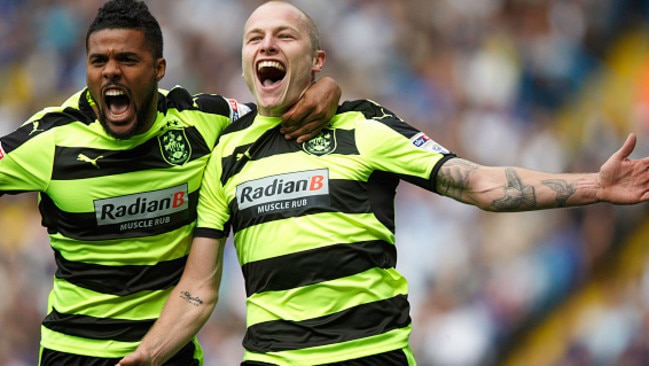 Aaron Mooy celebrates with Elias Kachunga after scoring for Huddersfield Town.