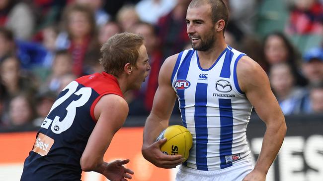 Bernie Vince grabs his stomach after being punched by Ben Cunnington.