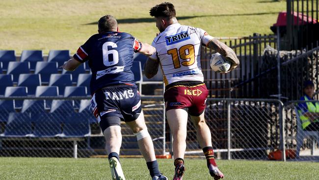 Try bound: Thirlmere's Curtis Scott gets past Chris Browne to score his first. Picture: John Appleyard