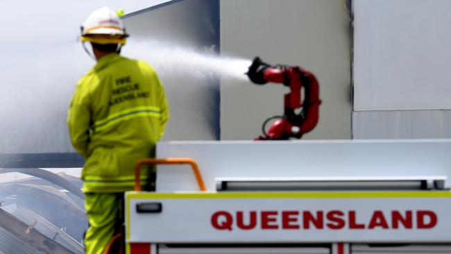 BRISBANE, AUSTRALIA - NewsWire Photos - DECEMBER 17, 2020.A fire truck douses with water the burnt remains of a recycling warehouse which was engulfed by massive blaze yesterday, at Hemmant in Brisbane's east.Picture: NCA NewsWire / Dan Peled