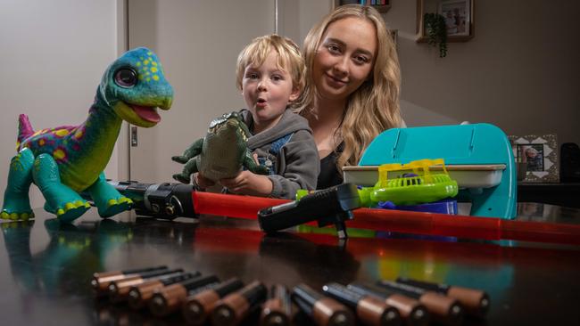 Emily Thiesz with her son Wilbur and some of his toys that need batteries. Picture: Brad Fleet