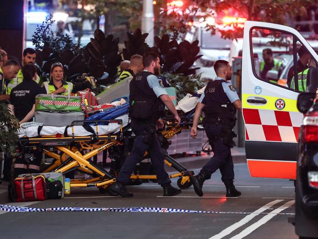 Police and paramedics work outside the Westfield Bondi Junction shopping mall after the stabbing rampage.