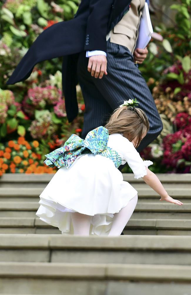 Princess Charlotte takes a tumble as the bridal party arrives. Picture: AP