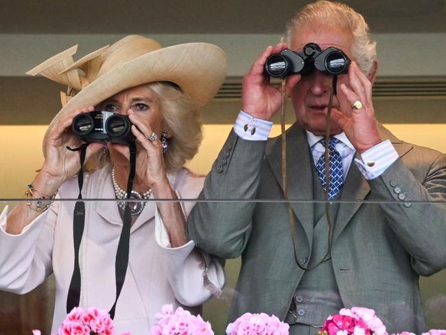 Britain's Queen Camilla (L) and Britain's King Charles III (R) watch the races with their binoculars on the second day of the Royal Ascot horse racing meeting, in Ascot, west of London, on June 21, 2023. (Photo by JUSTIN TALLIS / AFP)