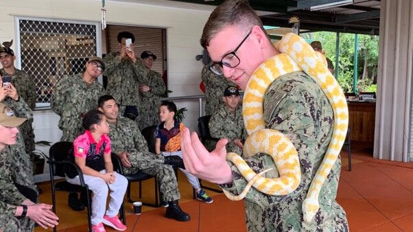 US sailors with a snake at the Burringilly Aboriginal Corporation Centre at Woodridge.