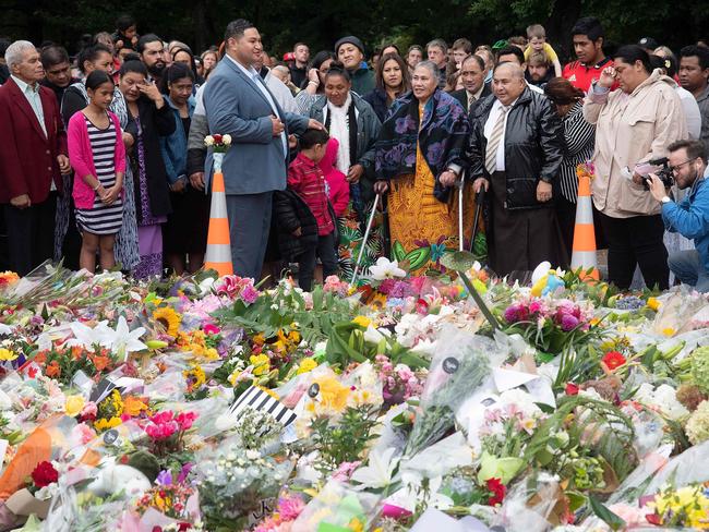 Samoan church members sing next to floral tributes for the victims of the Christchurch mosque shootings. Picture: AFP