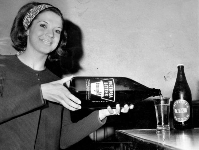 10/07/1968. Drinking. Lynette Winter, of Armadale, pours a drink from an 80oz. bottle today. On the right is a normal 26oz. bottle. Victoria Bitter. Beer. Beers. VB. (hsretro instagram 10/07/2023)