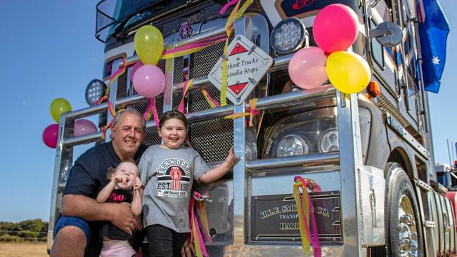 Five year old brain cancer battler Isabella and her sister Amelia with Atkinsons Dam truck drive Mike Bowden. Picture: Dominic Elsome