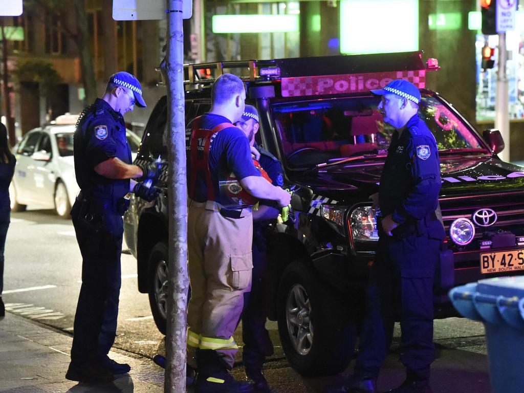 NSW Police officers subdue a man under the influence of methamphetamine on Kent St, in the Sydney CBD. Early reports stated that the offender had ripped out a piece of industrial piping and was threatening to stab pedestrians with it.  Picture: Gordon McComiskie