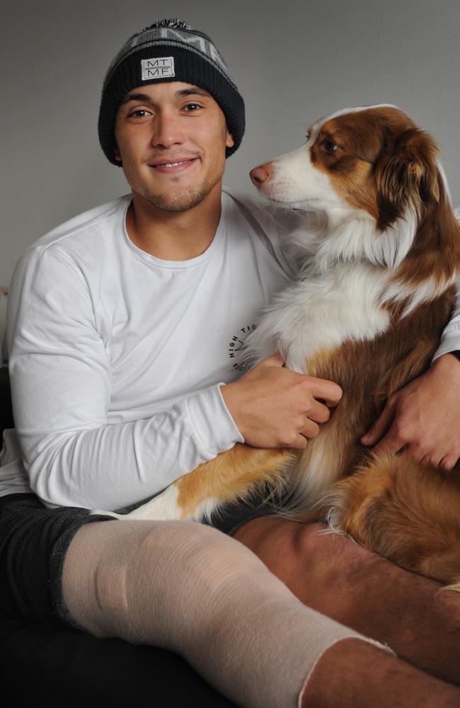 Alex Woodward recovering at home with his dog Koda last year.