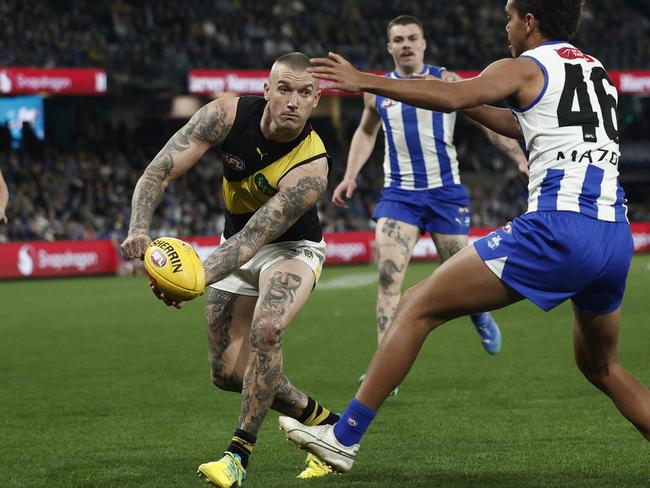 Martin handballs during his last game against North Melbourne. Picture: Daniel Pockett/Getty Images