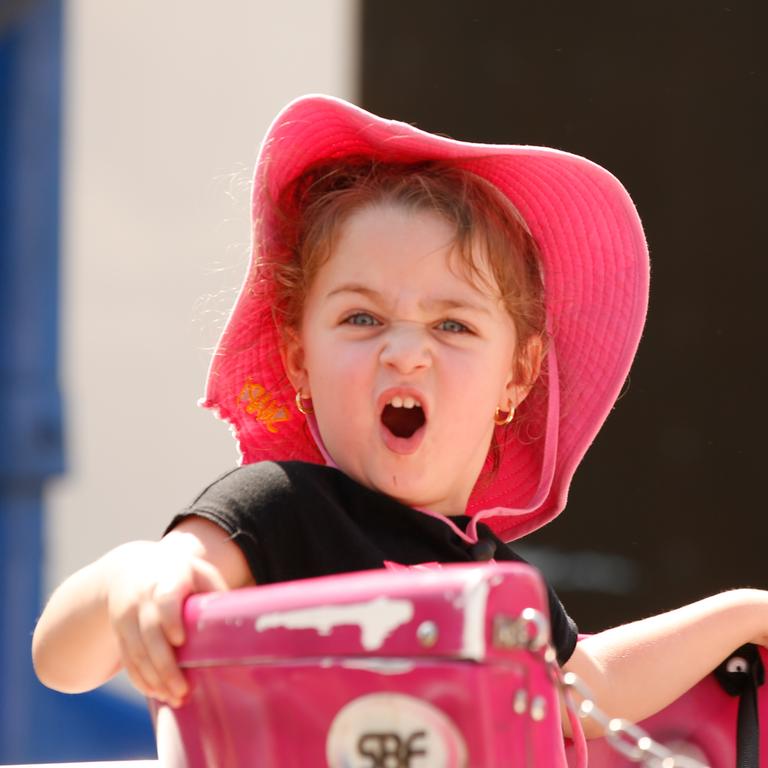 Cahali Angel, 3, “enjoying” the Tea Cup ride. Picture GLENN CAMPBELL