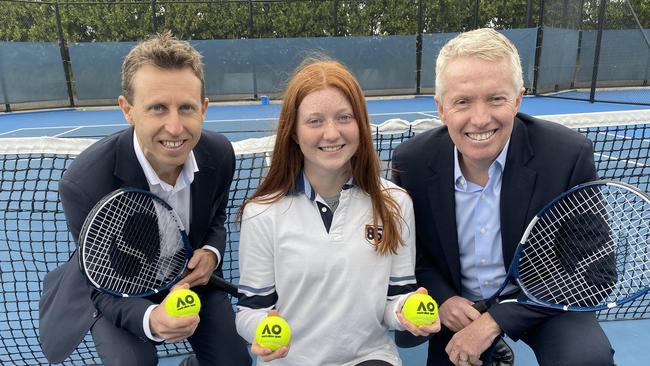 Tennis Australia Chief Operating Officer Tom Larner (left) and Tournament Director Craig Tiley (right) help launch the Australian Open alongside ball kid Susannah. Pic: Grace McKinnon