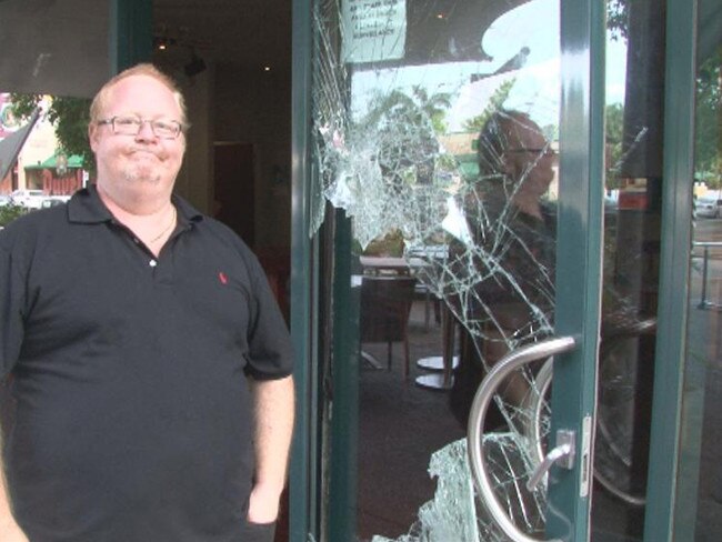 Prominent restaurateur and bar owner Jason Hanna stands by a window smashed during an earlier break-in at his Deck Bar. This particular break-in (pictured) happened in 2011.